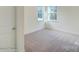 Well-lit bedroom with carpet and neutral walls at 2024 Embassy Ct # 49, Charlotte, NC 28213
