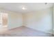 Simple bedroom with neutral carpeting and access to upstairs at 2024 Embassy Ct # 49, Charlotte, NC 28213