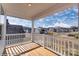 Enjoy a sunny view of the neighborhood from this home's deck, complete with a white railing and wood flooring at 2024 Embassy Ct # 49, Charlotte, NC 28213