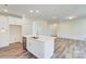 Open kitchen with white cabinets, large island, and stainless steel appliances at 2024 Embassy Ct # 49, Charlotte, NC 28213