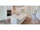 Modern kitchen with white cabinets and large island at 2024 Embassy Ct # 49, Charlotte, NC 28213