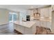 Open kitchen with white cabinets, island, and stainless steel appliances at 2024 Embassy Ct # 49, Charlotte, NC 28213