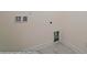 Small laundry area with tile flooring and built-in shelving at 2024 Embassy Ct # 49, Charlotte, NC 28213
