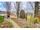 Landscaped backyard with stone path and shed at 3030 Talledaga Sw Ln, Concord, NC 28025