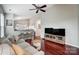 Living room with hardwood floors, couch, and a view of the kitchen at 3030 Talledaga Sw Ln, Concord, NC 28025