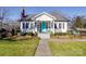 Charming white house with a porch and well-maintained landscaping at 502 W Trade St, Dallas, NC 28034