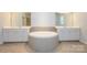 Elegant bathroom with double vanity, garden tub and tile flooring at 7542 Waverly Walk Ave # 7542, Charlotte, NC 28277