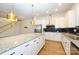 Modern kitchen with white cabinets, granite island, and stainless steel appliances at 7542 Waverly Walk Ave # 7542, Charlotte, NC 28277