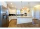 Modern kitchen with white cabinets, granite island, and stainless steel appliances at 7542 Waverly Walk Ave # 7542, Charlotte, NC 28277