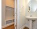 Modern powder room with pedestal sink and built-in shelving at 7542 Waverly Walk Ave # 7542, Charlotte, NC 28277