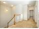 Upstairs hallway with carpet, staircase, and doors to bedrooms at 7542 Waverly Walk Ave # 7542, Charlotte, NC 28277
