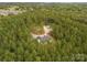 Aerial view of a home surrounded by lush forest, showcasing its secluded location at 997 Skyland S Dr, Mount Pleasant, NC 28124