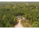 Aerial view of a home nestled in a wooded area with a long driveway at 997 Skyland S Dr, Mount Pleasant, NC 28124