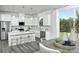 Open kitchen with white cabinets, island, stainless steel appliances, and gray flooring at 7224 Hodges Meadow Ln, Charlotte, NC 28213