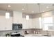White kitchen with upper cabinets, microwave, and tile backsplash at 7224 Hodges Meadow Ln, Charlotte, NC 28213