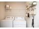 Bright laundry room with washer, dryer, and shelving at 7224 Hodges Meadow Ln, Charlotte, NC 28213
