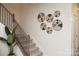 Stylish staircase with black metal railing and wall decor at 7224 Hodges Meadow Ln, Charlotte, NC 28213