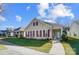 Charming yellow house with maroon shutters, welcoming porch, and landscaped yard at 10117 Bishops Gate Blvd, Pineville, NC 28134