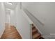 Light and bright hallway with wood-look floors and carpeted stairs at 14752 Lions Paw St, Charlotte, NC 28273