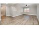 Bedroom with wood-look floors and access to a bathroom at 155 Mcadam Ln, Mooresville, NC 28117