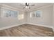 Bright bedroom featuring wood-look floors and ceiling fan at 155 Mcadam Ln, Mooresville, NC 28117
