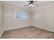 Well-lit bedroom with wood-look floors and a window at 155 Mcadam Ln, Mooresville, NC 28117