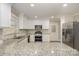 Modern kitchen with stainless steel appliances and granite countertops at 155 Mcadam Ln, Mooresville, NC 28117