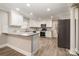 Modern kitchen with white cabinets, granite counters, and stainless steel appliances at 155 Mcadam Ln, Mooresville, NC 28117