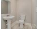 Clean powder room with pedestal sink and toilet at 155 Mcadam Ln, Mooresville, NC 28117
