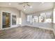 Sunroom with brick accent wall, multiple windows and doors at 155 Mcadam Ln, Mooresville, NC 28117