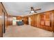 Living room with wood paneled walls and carpeting at 1586 S Oak Dr, Shelby, NC 28150