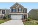 Two-story home with gray and blue siding, white garage door, and landscaping at 1804 Otter Perch Ln, Fort Mill, SC 29715