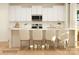 White kitchen island with seating for four in modern kitchen at 1984 Copper Path Dr, Fort Mill, SC 29715