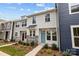 Two-story townhome with light gray and navy siding, stone accents, and a teal front door at 2009 Near Point Rd # 21, Charlotte, NC 28208