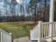 Serene backyard view from the porch, showcasing a large grassy area and trees at 38899 Dalton Ln, Albemarle, NC 28001