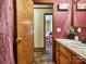 Neat bathroom with single sink vanity and view of bedroom at 38899 Dalton Ln, Albemarle, NC 28001