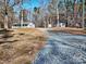 Ranch home with front porch and detached garage, nestled in a wooded setting at 38899 Dalton Ln, Albemarle, NC 28001