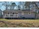 Rear view of a ranch home showcasing a deck and private yard at 38899 Dalton Ln, Albemarle, NC 28001