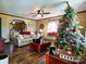 Spacious living room with a Christmas tree, comfortable seating, and view to kitchen at 38899 Dalton Ln, Albemarle, NC 28001