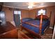 Spacious bedroom with wood post bed frame, ceiling fan and hardwood floor at 4401 Lamar Ave, Gastonia, NC 28056