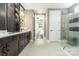 Spa-like bathroom featuring a walk-in shower, dark brown vanity, and a view of the bedroom at 5089 Valita Rd, York, SC 29745