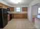 Galley kitchen with wood cabinets and tile floor at 683 Sweeney St, Chester, SC 29706