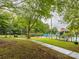 Community pool with surrounding patio furniture and lush landscaping at 7223 Winery Ln, Charlotte, NC 28227