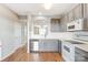 Modern kitchen with gray cabinets and white appliances at 928 Azurine Cir, Fort Mill, SC 29708