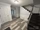 Spacious entryway with dark wood stairs and luxury vinyl plank flooring at 1364 5Th Street Nw Cir, Hickory, NC 28601