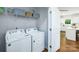 Bright laundry room with washer, dryer, and shelving at 1373 6Th Ne St, Hickory, NC 28601