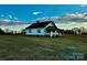 White farmhouse with stone accents and large yard at 2241 W Chester School Rd, Chester, SC 29706