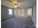 Spacious bedroom with carpet, ceiling fan, and access to bathroom at 5542 Whistlewood Ln, Charlotte, NC 28208