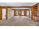 Living room with hardwood floors, wood paneling, and large windows at 8031 Nathanael Greene Ln, Charlotte, NC 28227