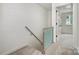 Upstairs hallway with white brick and modern staircase at 1210 Green Oaks Ln # G, Charlotte, NC 28205